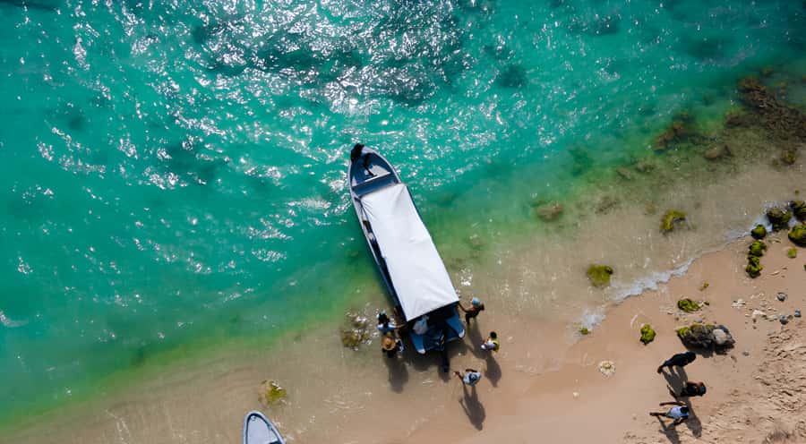Cartagena: Tour to Playa Tranquila with Snorkeling + Luminous Plankton and Parasol - Getting there: air-conditioned bus, fast boat, and Rosario Islands views